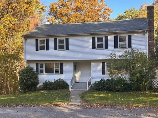 a front view of a house with a garden and yard