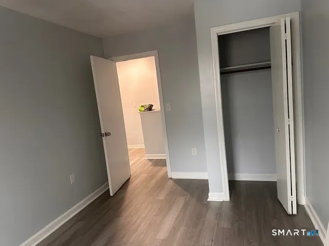 a view of hallway with stairs and wooden floor