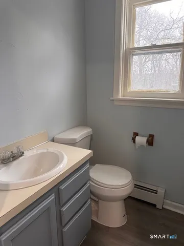 a bathroom with a toilet sink and window