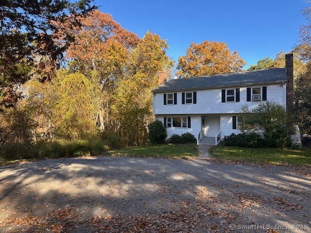 259 Westchester Road, Unit A Colchester, CT 06415 - Photo 24 of 24 a view of a big house with a big yard and large tree