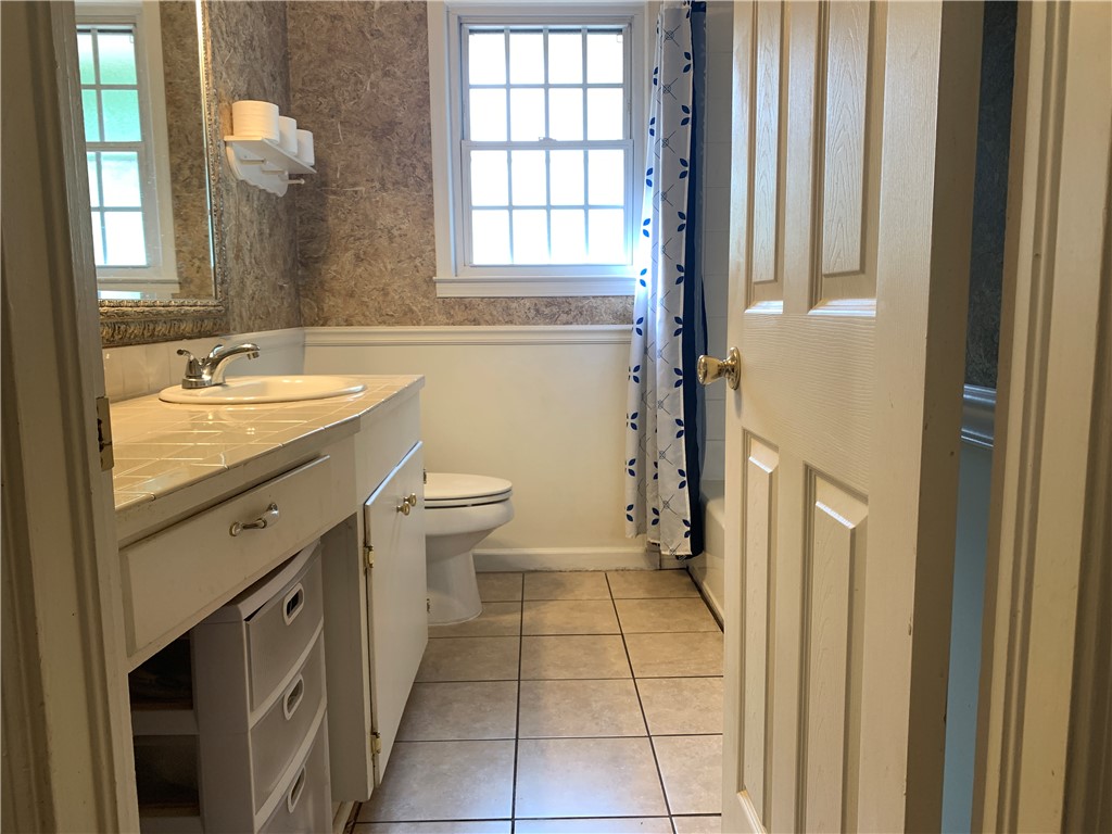 224 Polaris Street Anderson, SC 29621 - Photo 17 of 30 This bright bathroom features a vanity, tiled countertop, and a window for natural light.