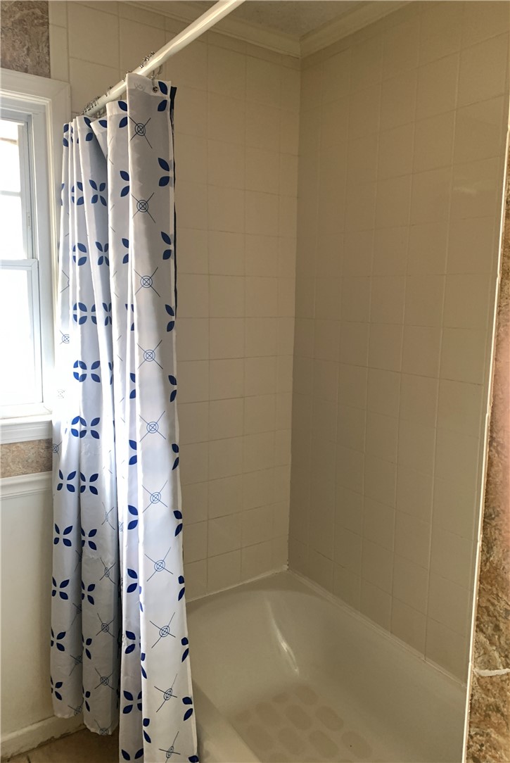 224 Polaris Street Anderson, SC 29621 - Photo 18 of 30 This bathroom features a classic bathtub and tiled walls, creating a clean and functional space.