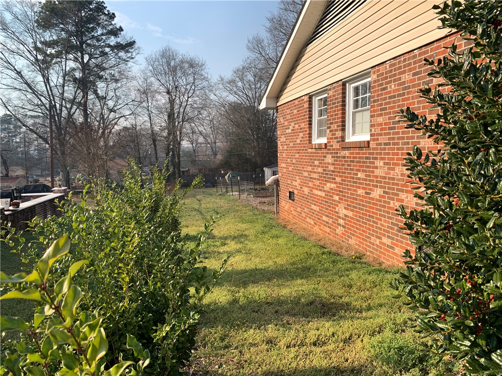 224 Polaris Street Anderson, SC 29621 - Photo 24 of 30 Left side view. Mature shrubbery to backyard.