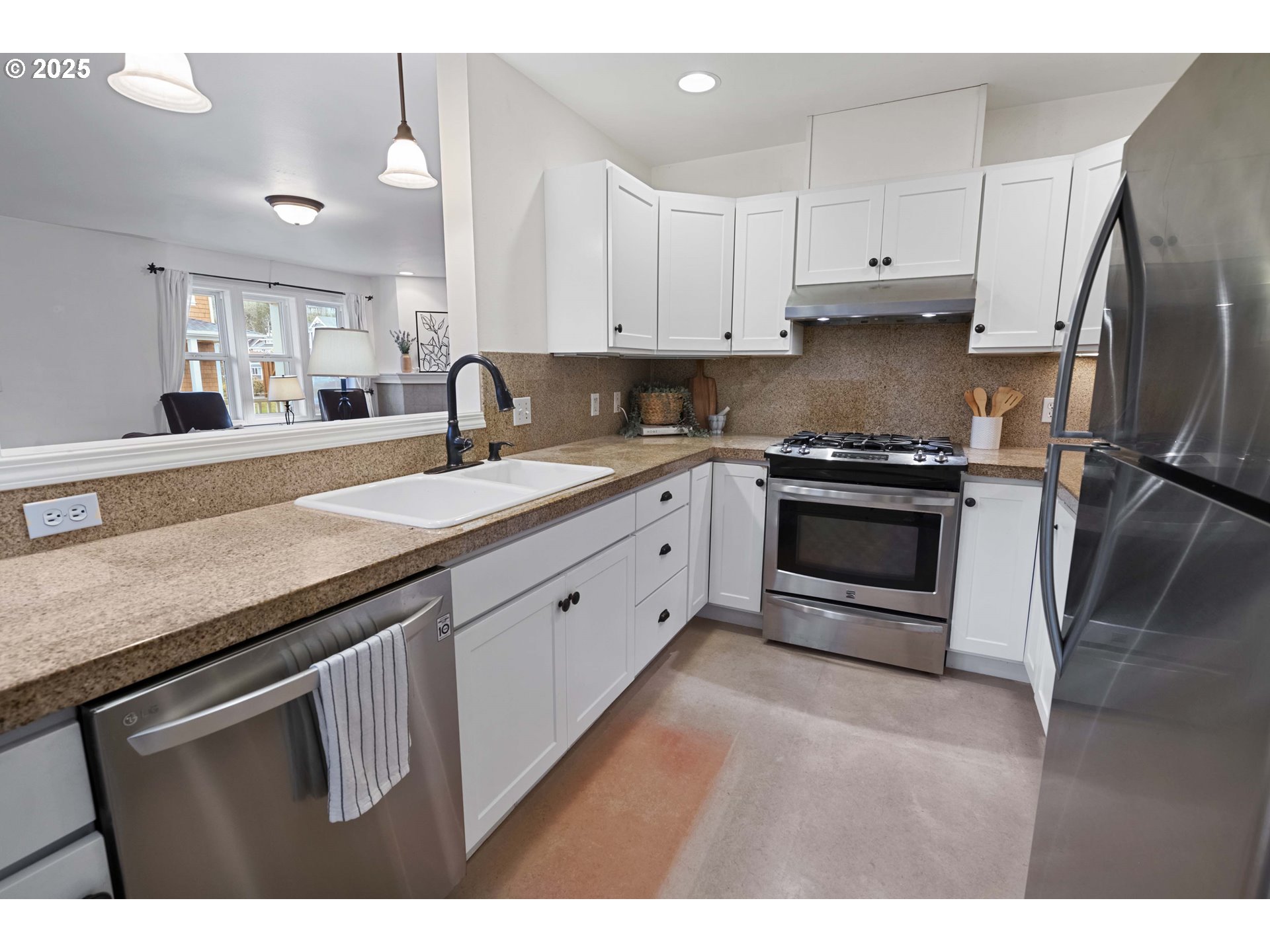 265 23rd Street Astoria, OR 97103 - Photo 11 of 36 a kitchen with granite countertop a stove sink and refrigerator
