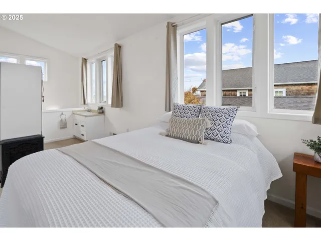 a bedroom with a large bed and a large window