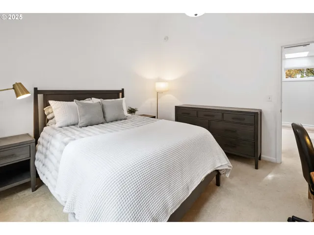 a bedroom with a bed and a night stand