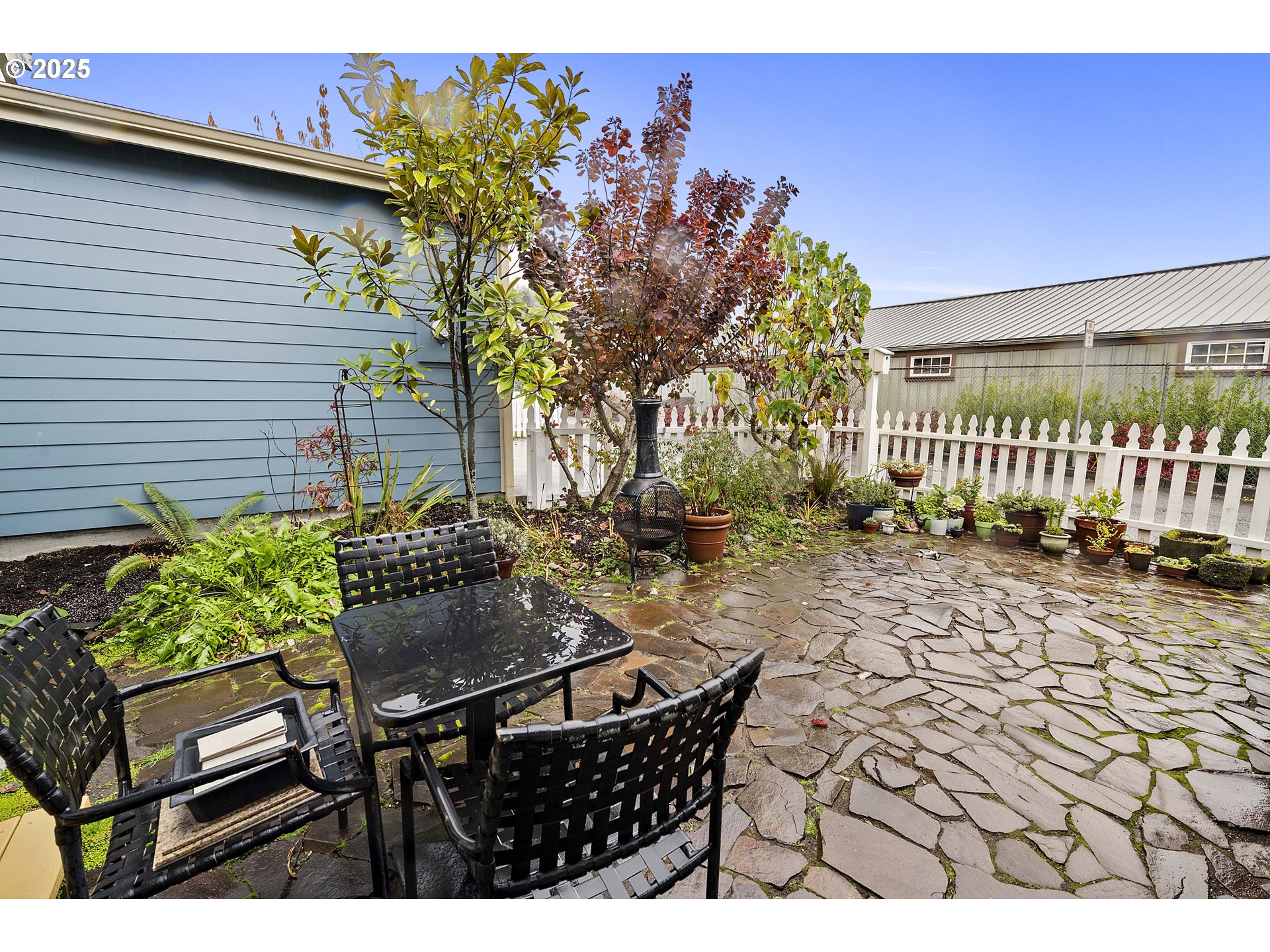 265 23rd Street Astoria, OR 97103 - Photo 30 of 36 a backyard of a house with table and chairs