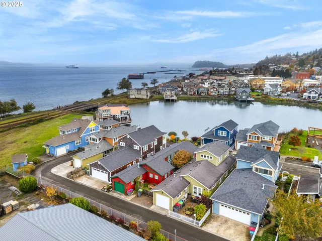 an aerial view of a house with outdoor seating
