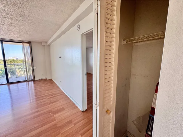 a view of hallway with wooden floor