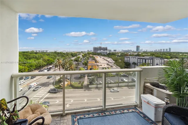a view of a balcony with wooden floor and city view