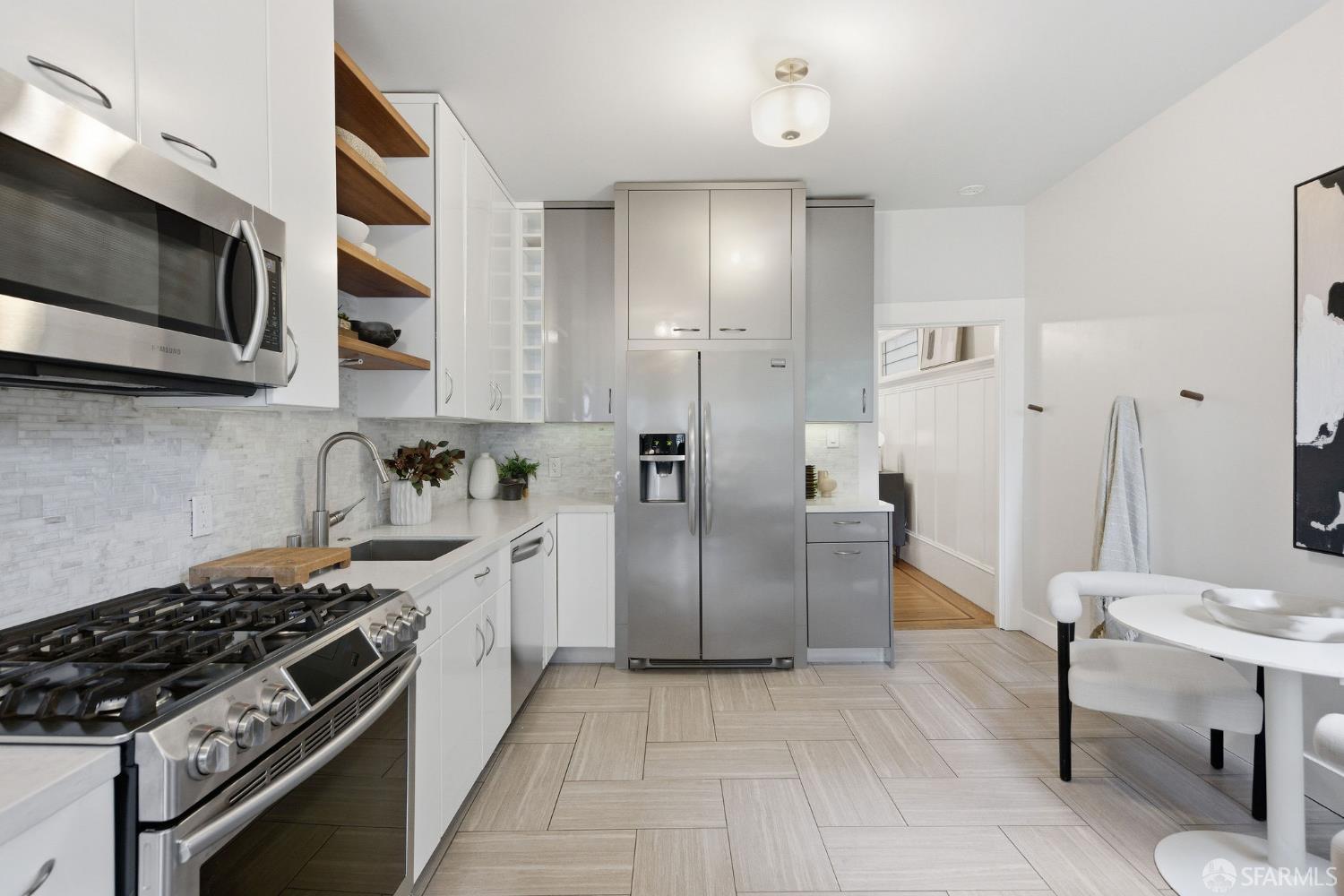 3452 18th Street, Unit A San Francisco, CA 94110 - Photo 14 of 39 a kitchen with stainless steel appliances granite countertop a stove a sink and a microwave