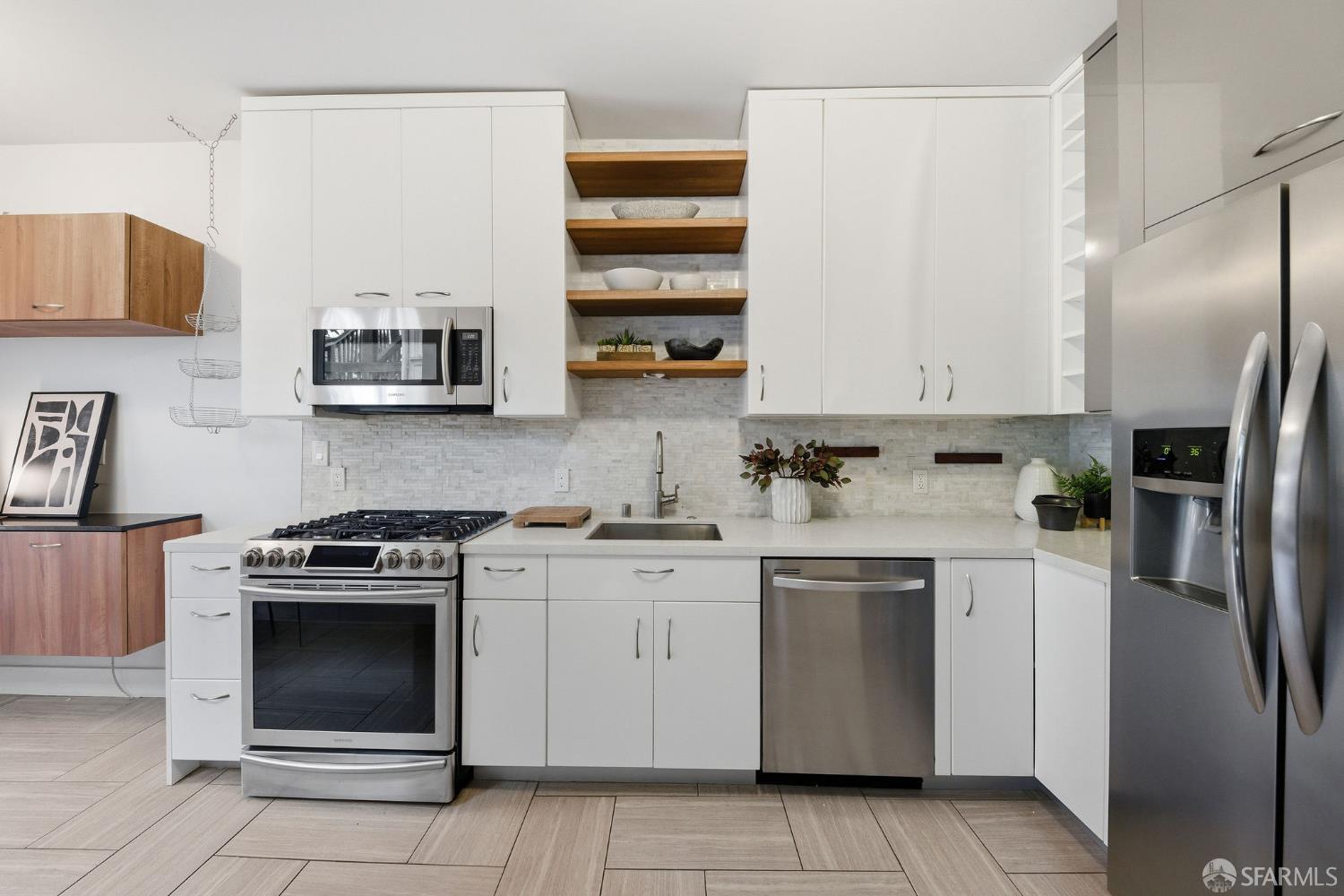 3452 18th Street, Unit A San Francisco, CA 94110 - Photo 16 of 39 a kitchen with stainless steel appliances granite countertop a stove top oven