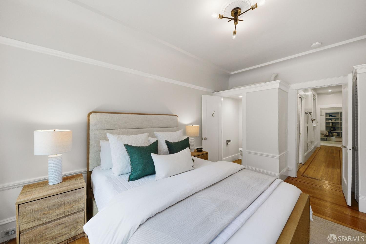 3452 18th Street, Unit A San Francisco, CA 94110 - Photo 22 of 39 a bedroom with a bed and wooden floor