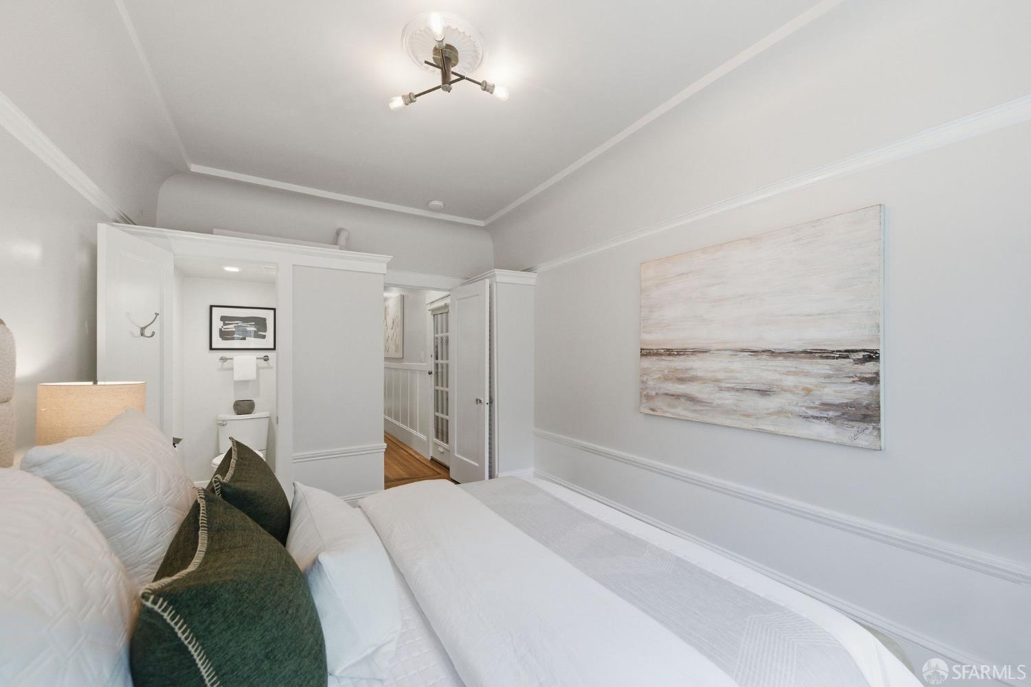 3452 18th Street, Unit A San Francisco, CA 94110 - Photo 23 of 39 a bed room with a bed and a painting