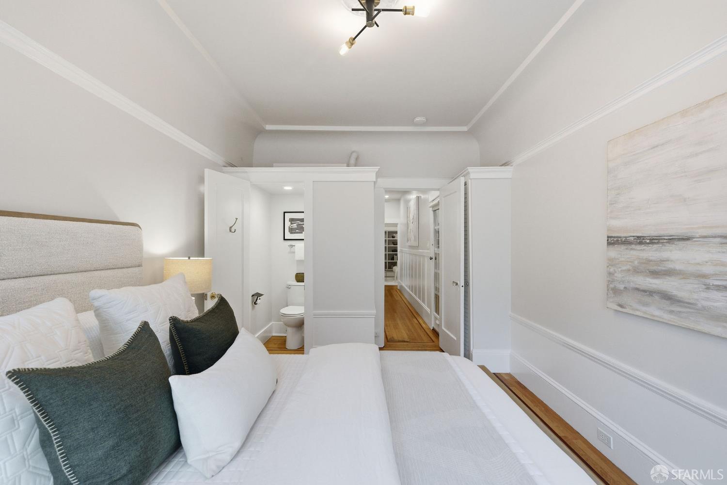 3452 18th Street, Unit A San Francisco, CA 94110 - Photo 24 of 39 a bed room with a bed and a walk in closet