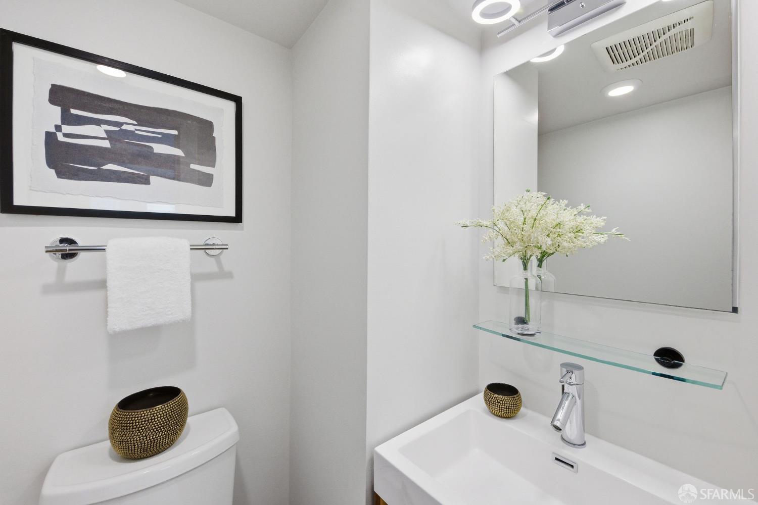3452 18th Street, Unit A San Francisco, CA 94110 - Photo 25 of 39 a bathroom with a sink and mirror
