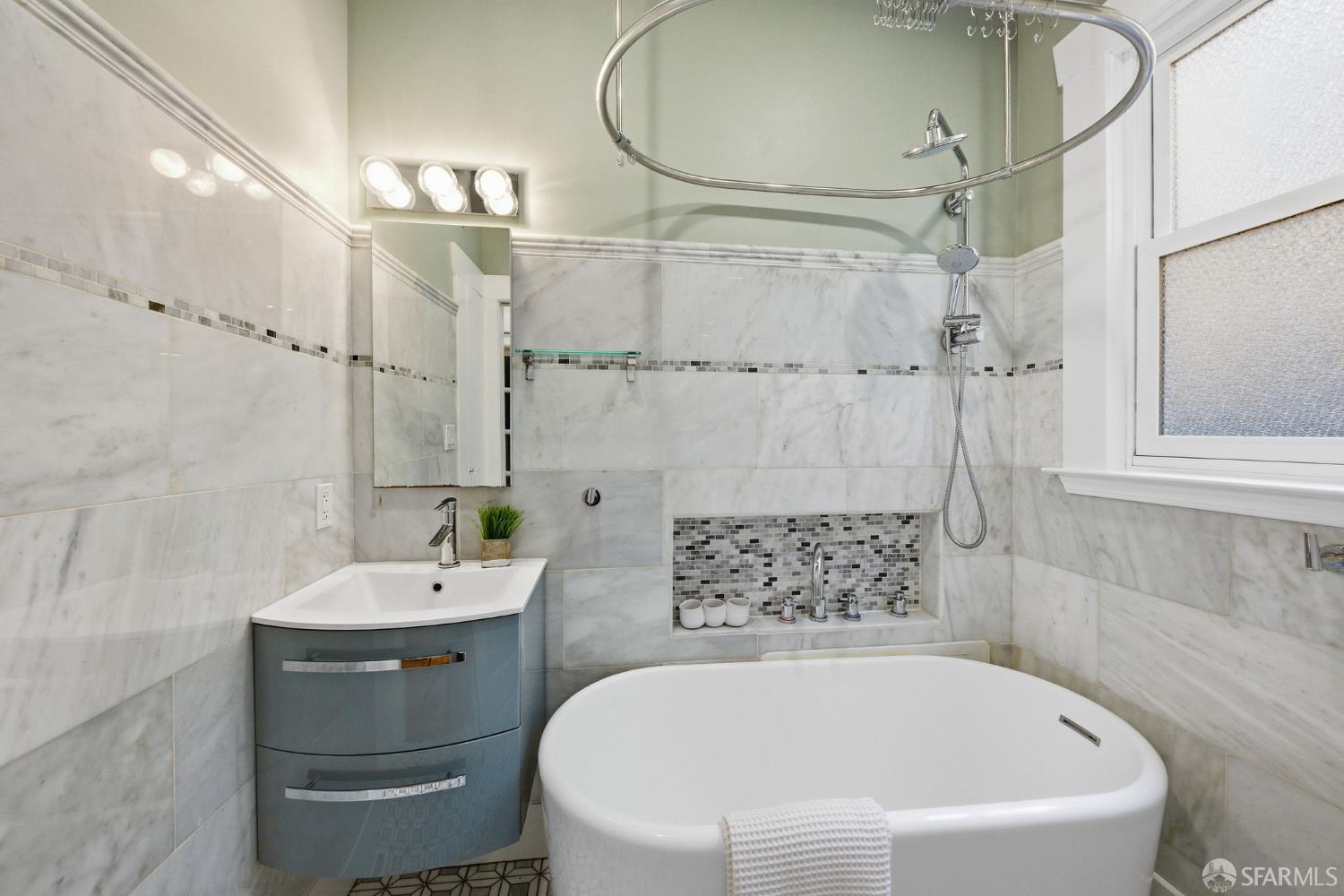 3452 18th Street, Unit A San Francisco, CA 94110 - Photo 28 of 39 a bathroom with a white bath tub a sink and white walls