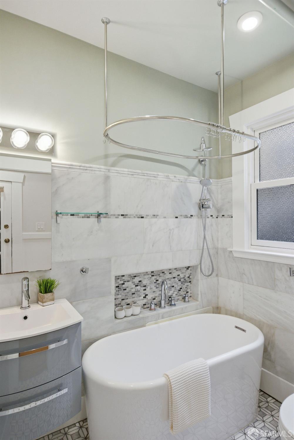 3452 18th Street, Unit A San Francisco, CA 94110 - Photo 30 of 39 a white bath tub sitting next to a white sink and vanity