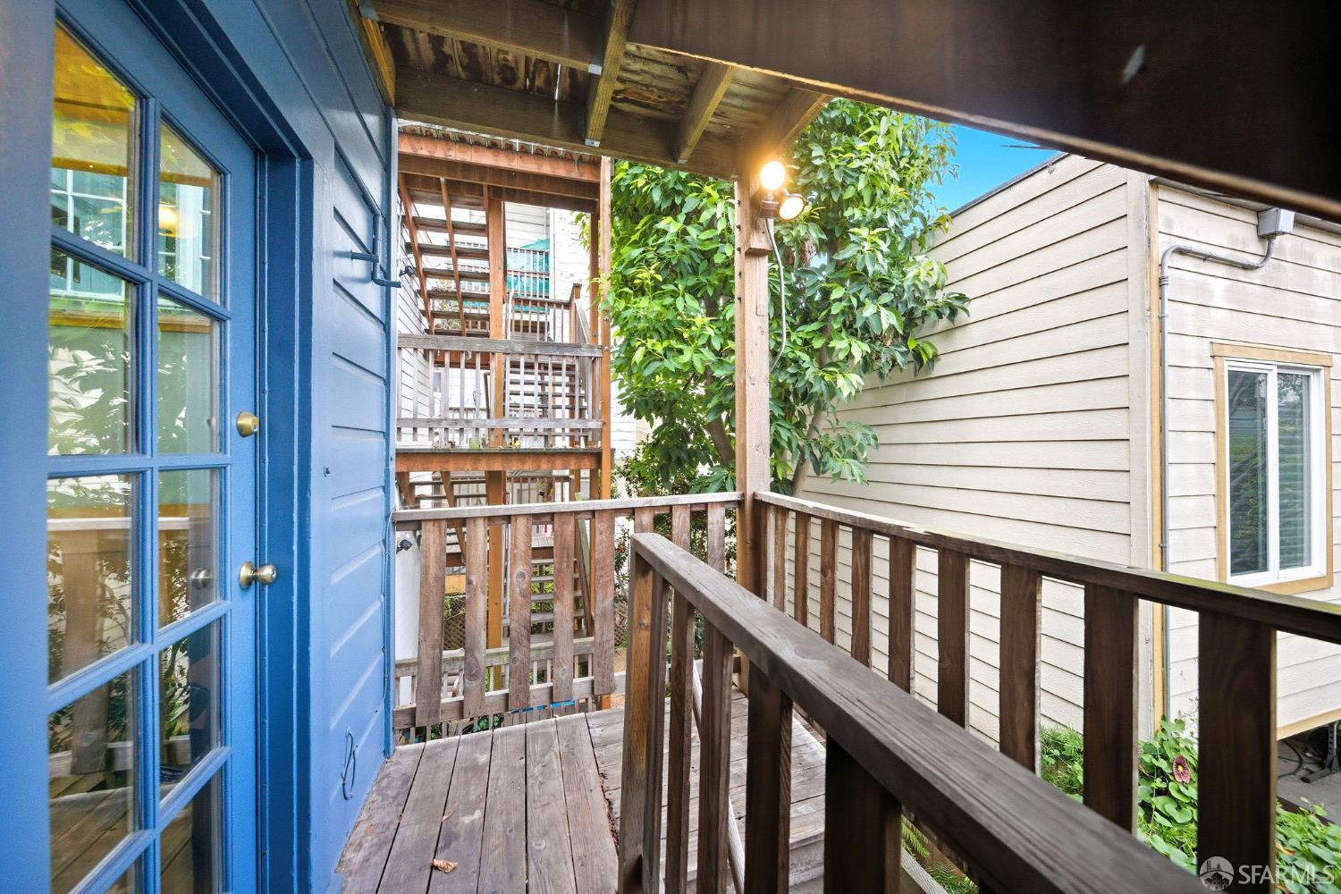 3452 18th Street, Unit A San Francisco, CA 94110 - Photo 35 of 39 a view of balcony with floor to ceiling window and wooden floor