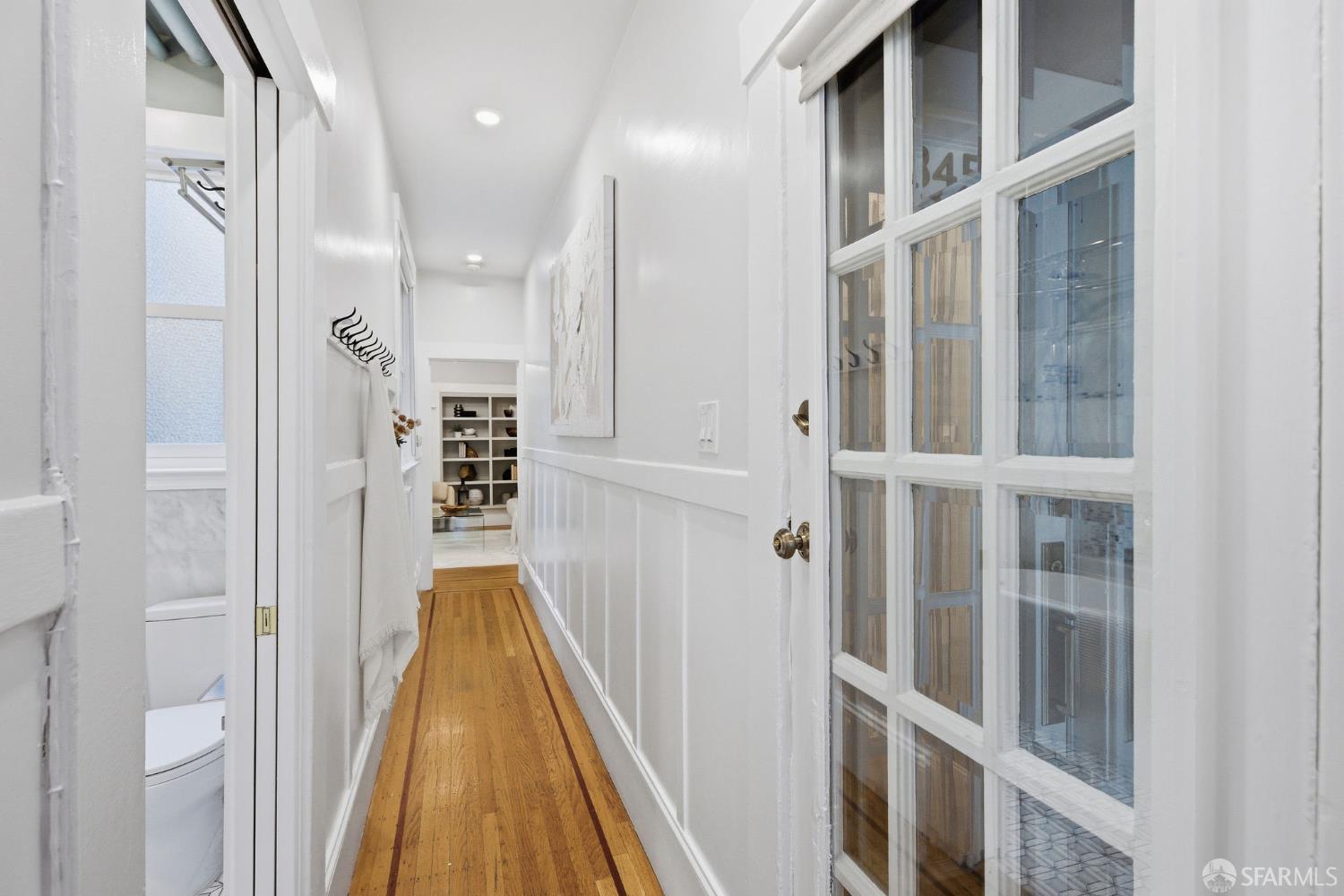 3452 18th Street, Unit A San Francisco, CA 94110 - Photo 4 of 39 a view of a hallway with wooden floor and staircase