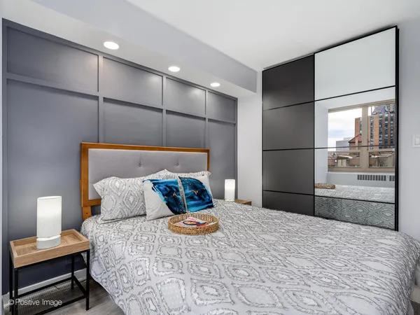 a bedroom with a bed and a mirror