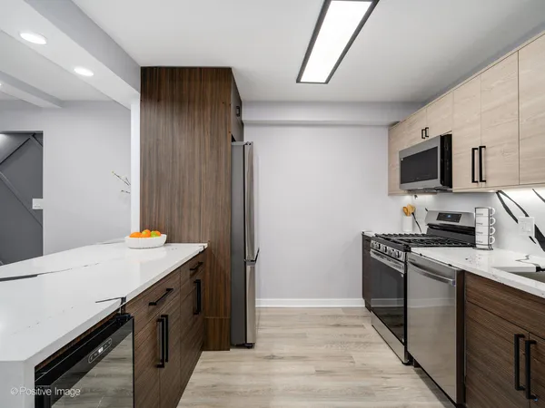a kitchen with granite countertop a sink a stove and microwave