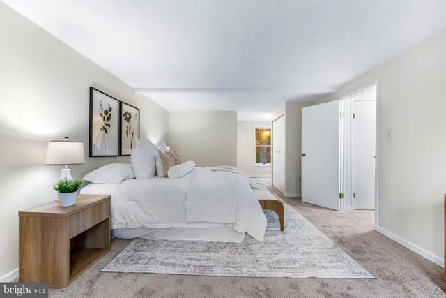 a bedroom with a bed and a night stand