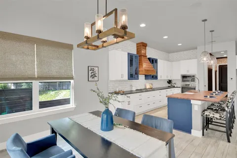 a living room with fireplace furniture and a chandelier