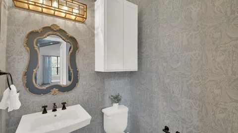 a bedroom with a bed a table and chair