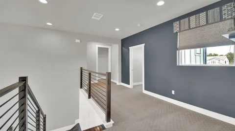 a bedroom with a large bed and a potted plant