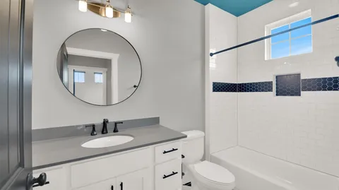 a bedroom with a bed and a large mirror