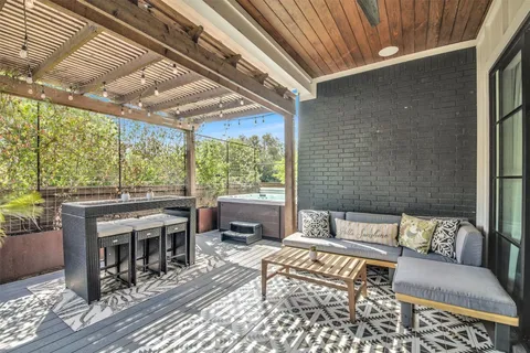 a living room with a large window and furniture