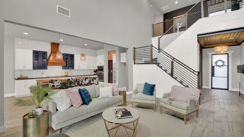 a living room with fireplace furniture and a large window