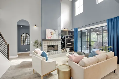 a living room with furniture a fireplace and a flat screen tv