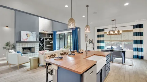 a kitchen with cabinets table and chairs