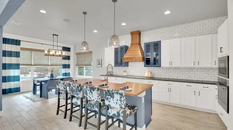 a kitchen with granite countertop a sink and a stove