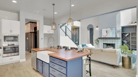 a kitchen with a sink a stove a dining table and chairs
