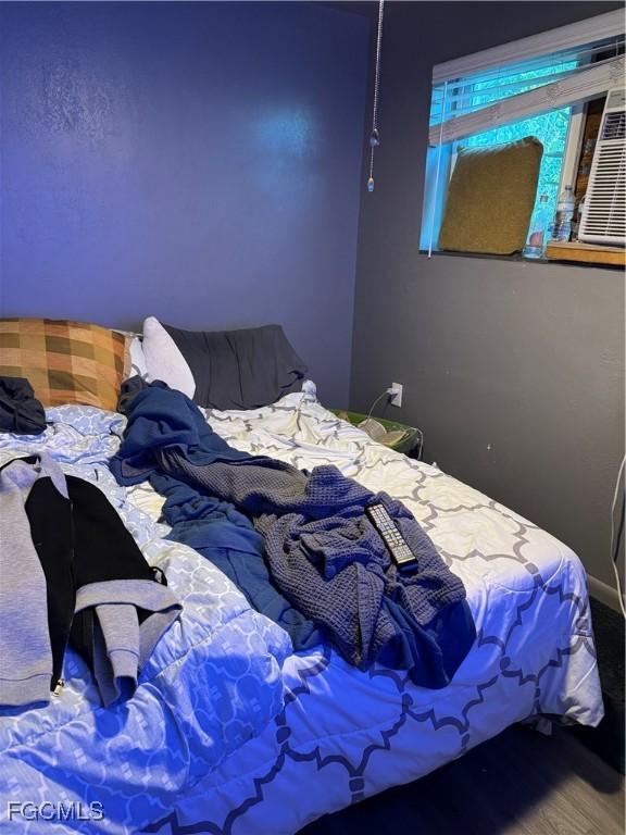 32576 Oil Well Road Punta Gorda, FL 33955 - Photo 13 of 30 a bedroom with a bed and a painting on the wall