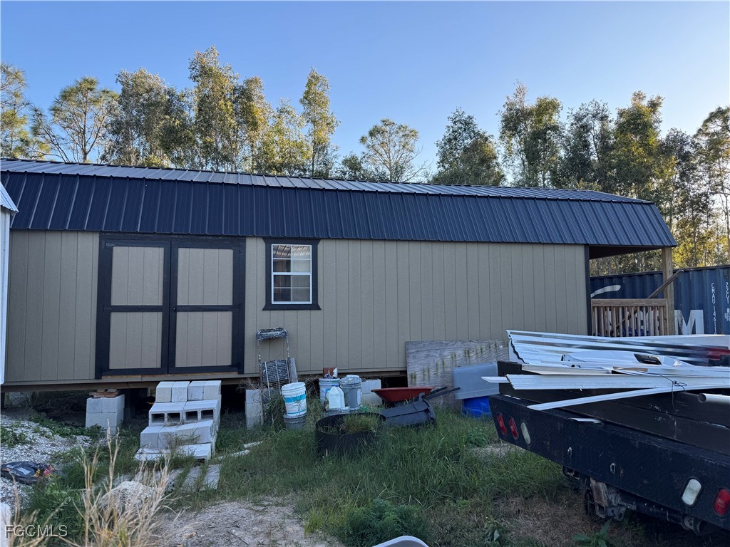 32576 Oil Well Road Punta Gorda, FL 33955 - Photo 18 of 30 a backyard of a house with wooden fence and trees