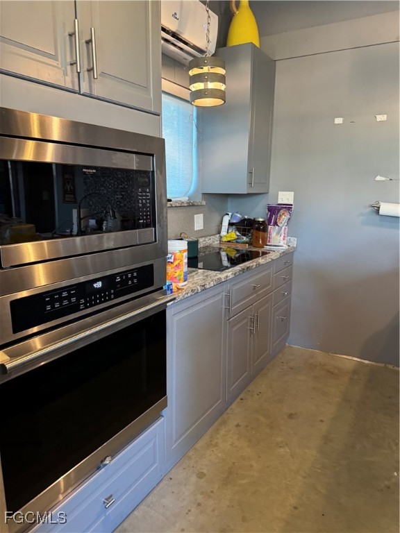 32576 Oil Well Road Punta Gorda, FL 33955 - Photo 9 of 30 a kitchen with stainless steel appliances a stove and a microwave