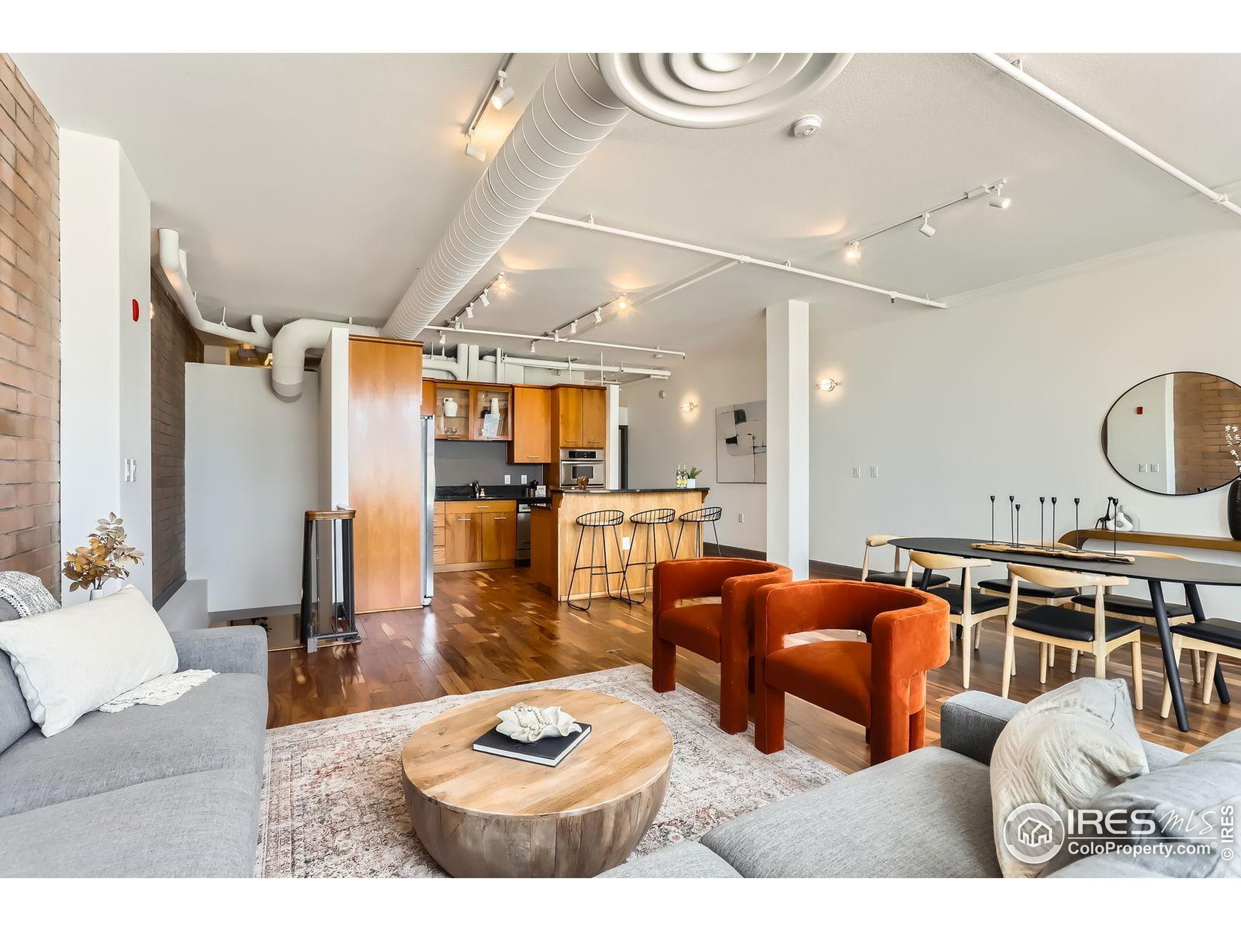 2245 Blake Street, Unit D Denver, CO 80205 - Photo 11 of 36 a living room with furniture kitchen view and a wooden floor