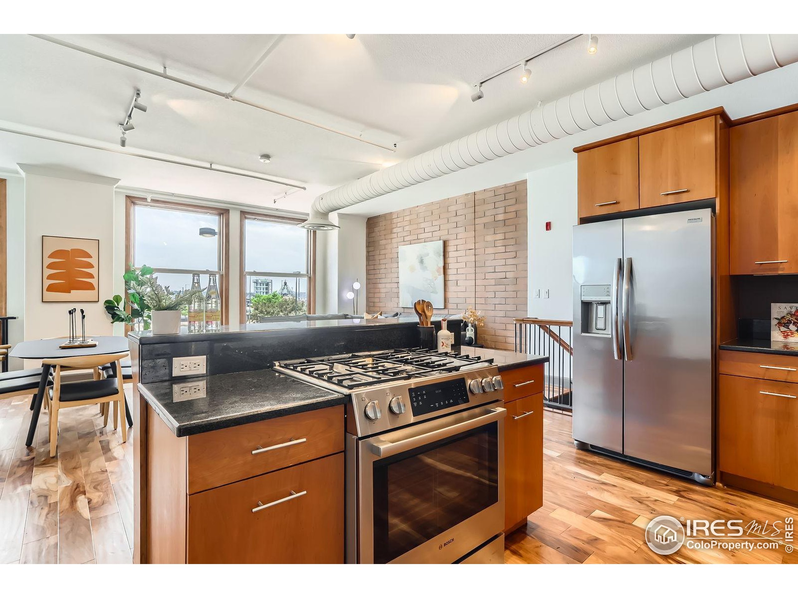 2245 Blake Street, Unit D Denver, CO 80205 - Photo 14 of 36 a kitchen with stainless steel appliances granite countertop a stove refrigerator sink and dishwasher