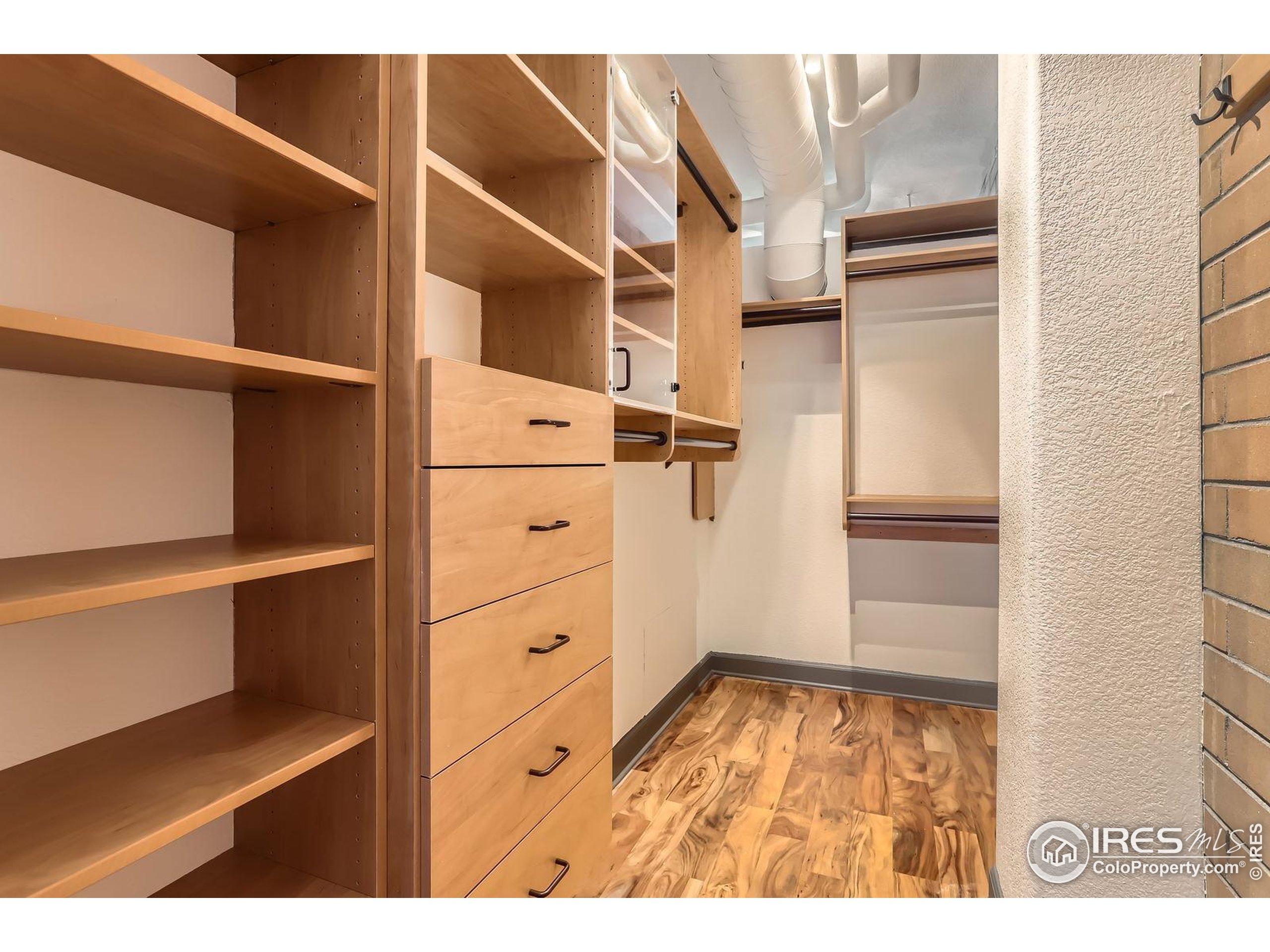 2245 Blake Street, Unit D Denver, CO 80205 - Photo 19 of 36 a view of walk in closet with empty racks