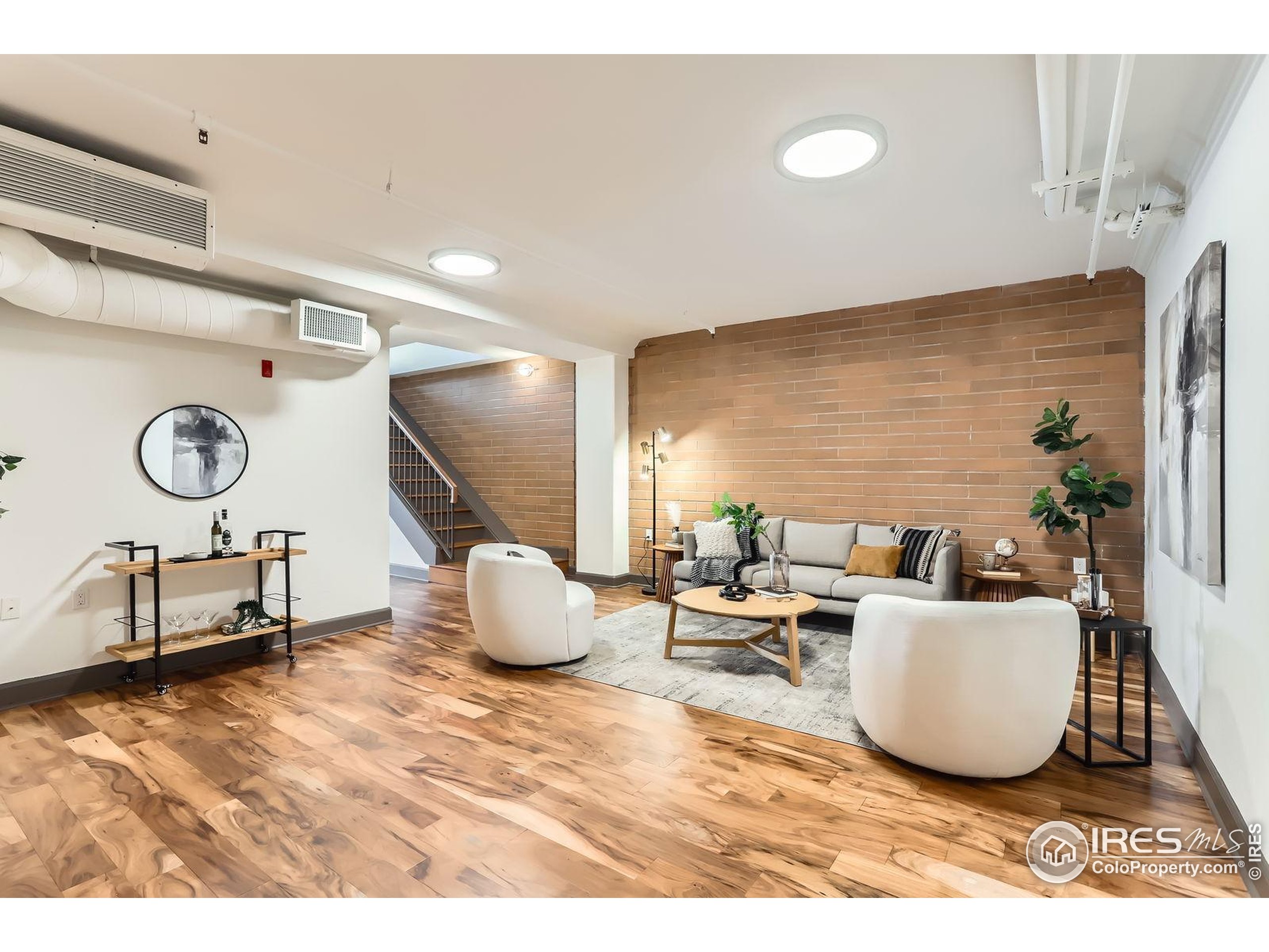 2245 Blake Street, Unit D Denver, CO 80205 - Photo 4 of 36 a living room with a couch and a table