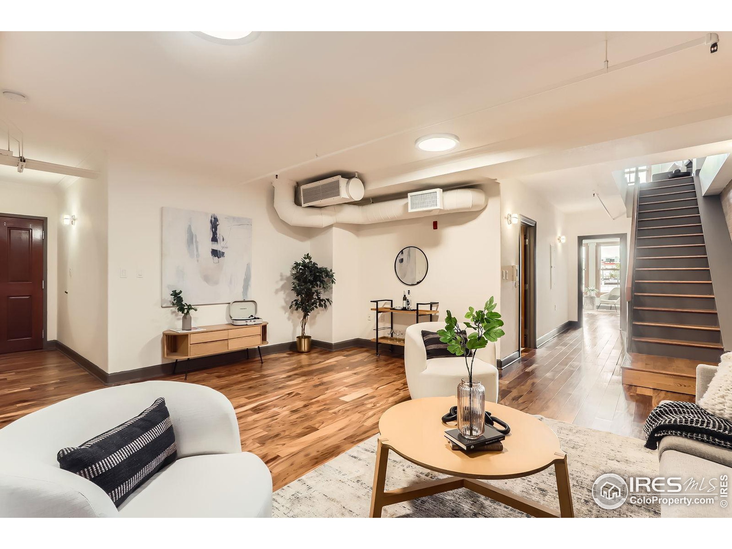 2245 Blake Street, Unit D Denver, CO 80205 - Photo 5 of 36 a living room with furniture and wooden floor