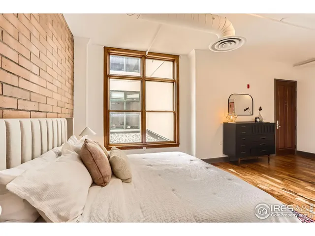 a bedroom with a bed dresser and a window