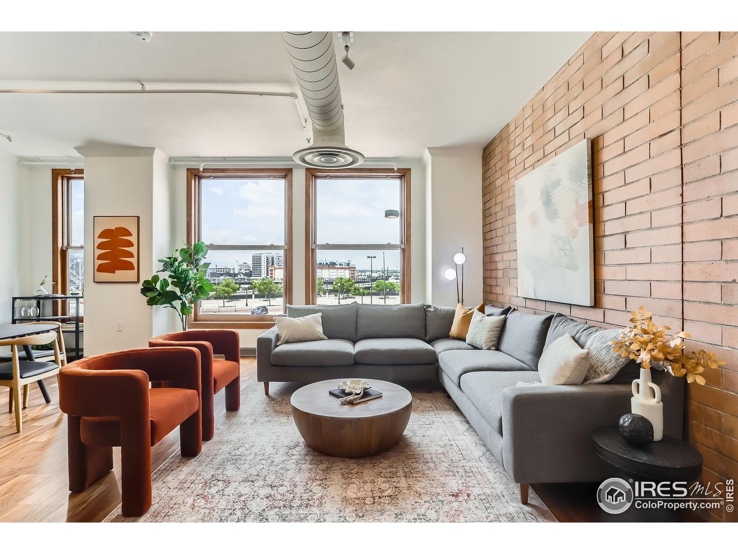 2245 Blake Street, Unit D Denver, CO 80205 - Photo 10 of 36 a living room with furniture and a large window