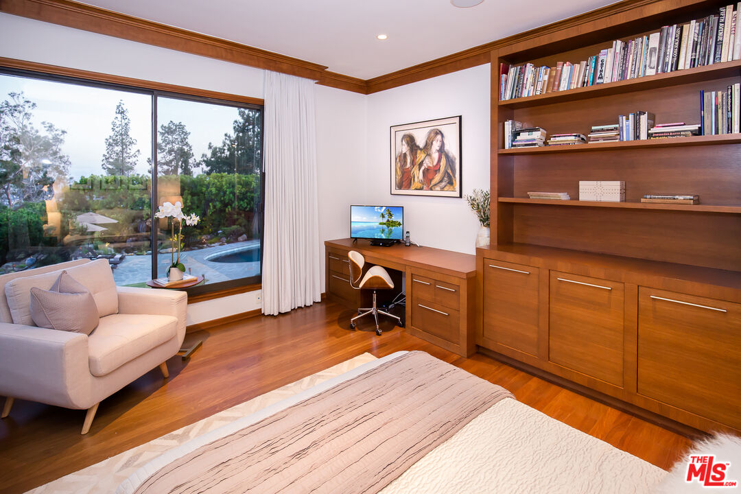 1131 Miradero Road Beverly Hills, CA 90210 - Photo 24 of 42 a work room with furniture and a book shelf