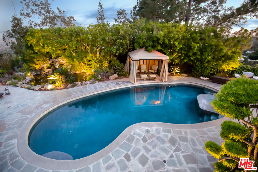 1131 Miradero Road Beverly Hills, CA 90210 - Photo 39 of 42 a view of a swimming pool with a yard