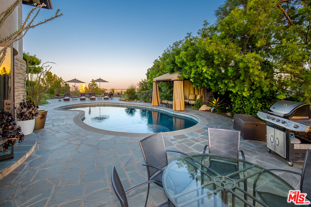 1131 Miradero Road Beverly Hills, CA 90210 - Photo 40 of 42 a view of a patio with swimming pool